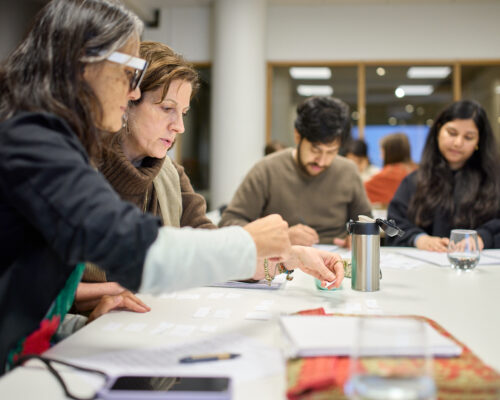 fyra deltagare vid ett bord jobbar me duppgifter